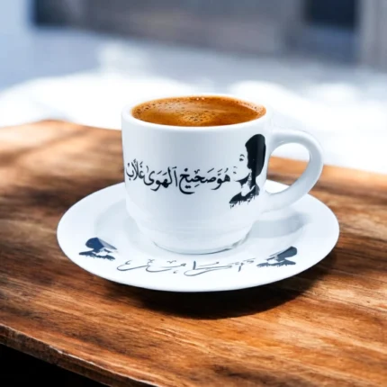 فنجان قهوه أم كلثوم بورسلين – تصميم كوبليه "هو صحيح الهوي غلاب" – أبيض × أسود – 6×8 سم