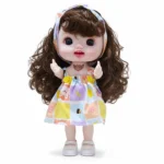 عروسة أطفال 23 سم بشعر بني كيرلي طويل وعيون كبيرة لامعة – دمية بناتي بفستان ملون وطوق رأس أنيق