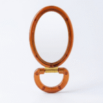 مراية عسلي بيضاوية 16×8 سم – مرآة يد أنيقة بتصميم كلاسيكي لون عسلي شفاف